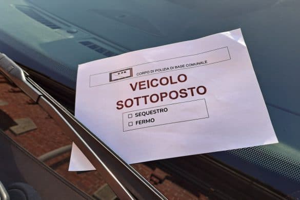 Administrative seizure of car, vehicle subject to seizure or seizure. Sheet of paper with writing in Italian, copy space.
