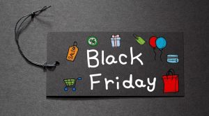 Black Friday text on a black tag on black paper background