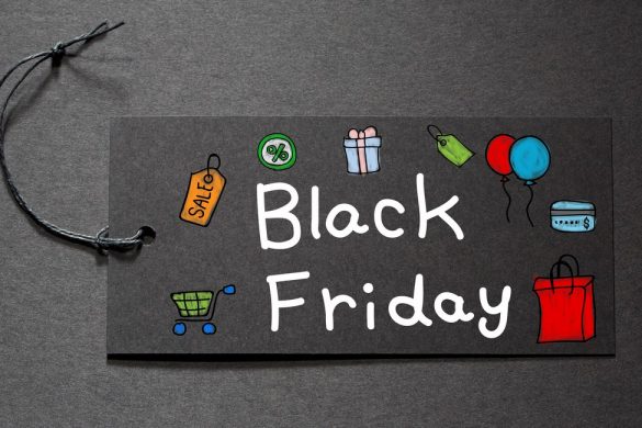 Black Friday text on a black tag on black paper background