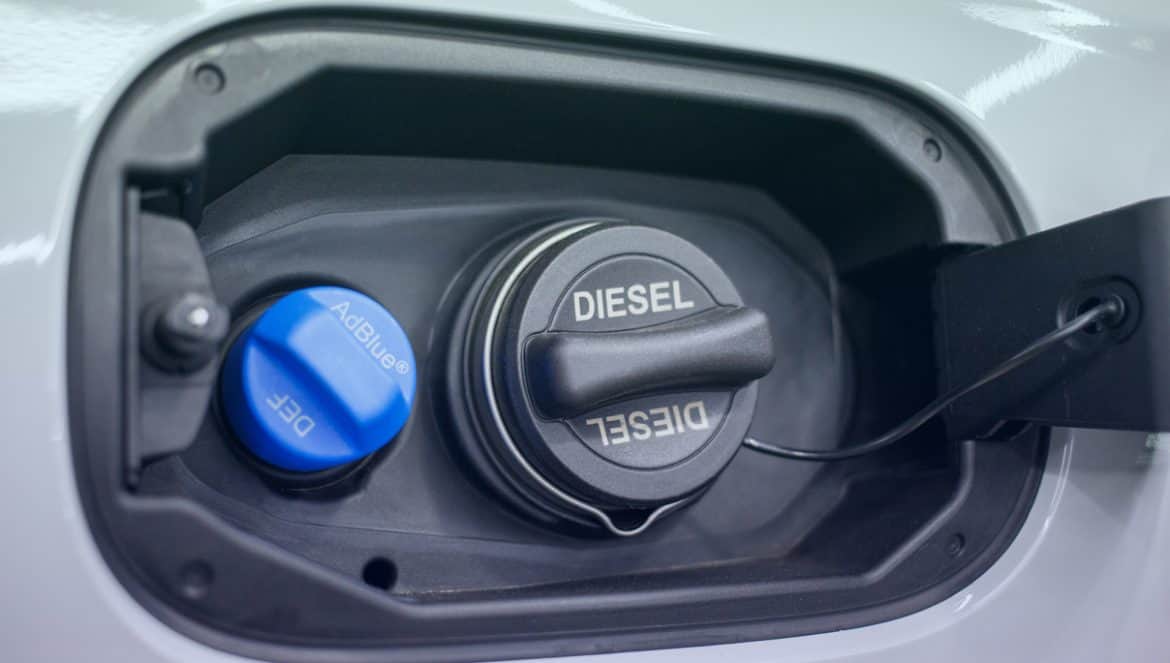 Tank filler neck for AdBlue and Diesel fuel close-up. Adblue diesel exhaust fluid fuel tank cap. Close up Adblue Diesel exhaust fluid DEF and fuel tank cap.