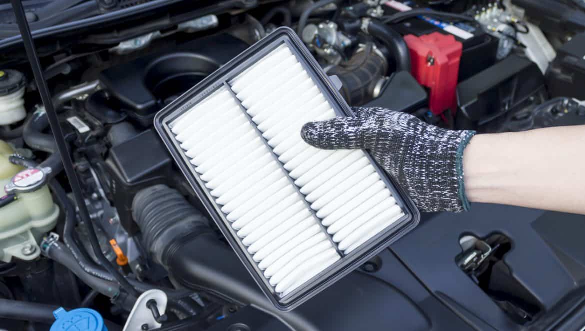 Auto mechanic hand with new car engine air filter, Car maintenance service.