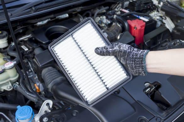 Auto mechanic hand with new car engine air filter, Car maintenance service.