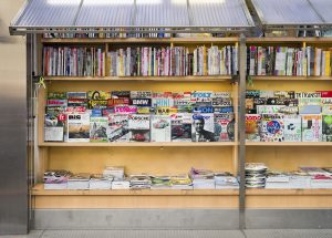 A large selection of magazine titles on display outside a kiosk in Tokyo, Japan.