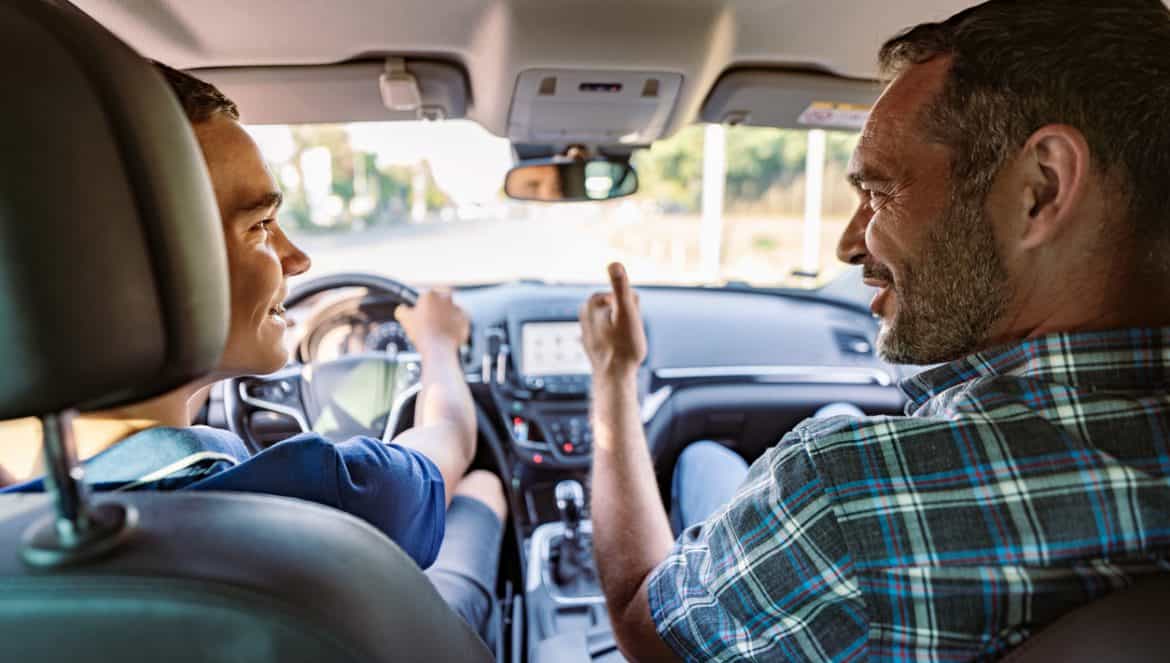 Driving instructor sitting his student and explain to him car driving basics, how to properly prepare himself for a drive. View from inside.