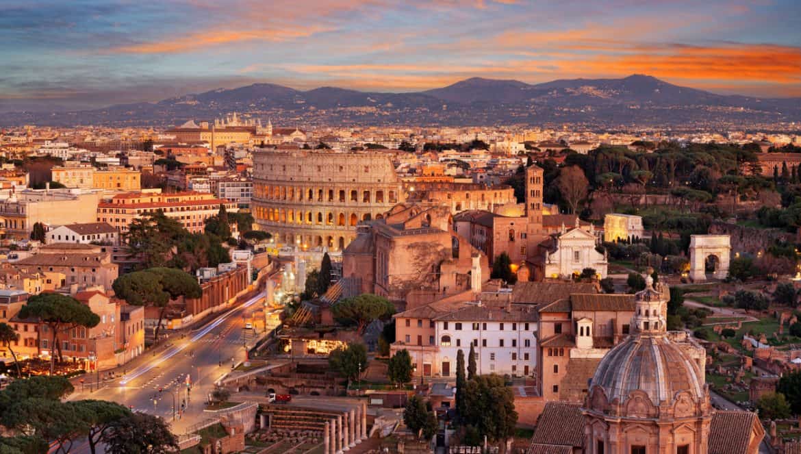 Rome, Italy view towards the Colosseum with archeological areas at sunset.