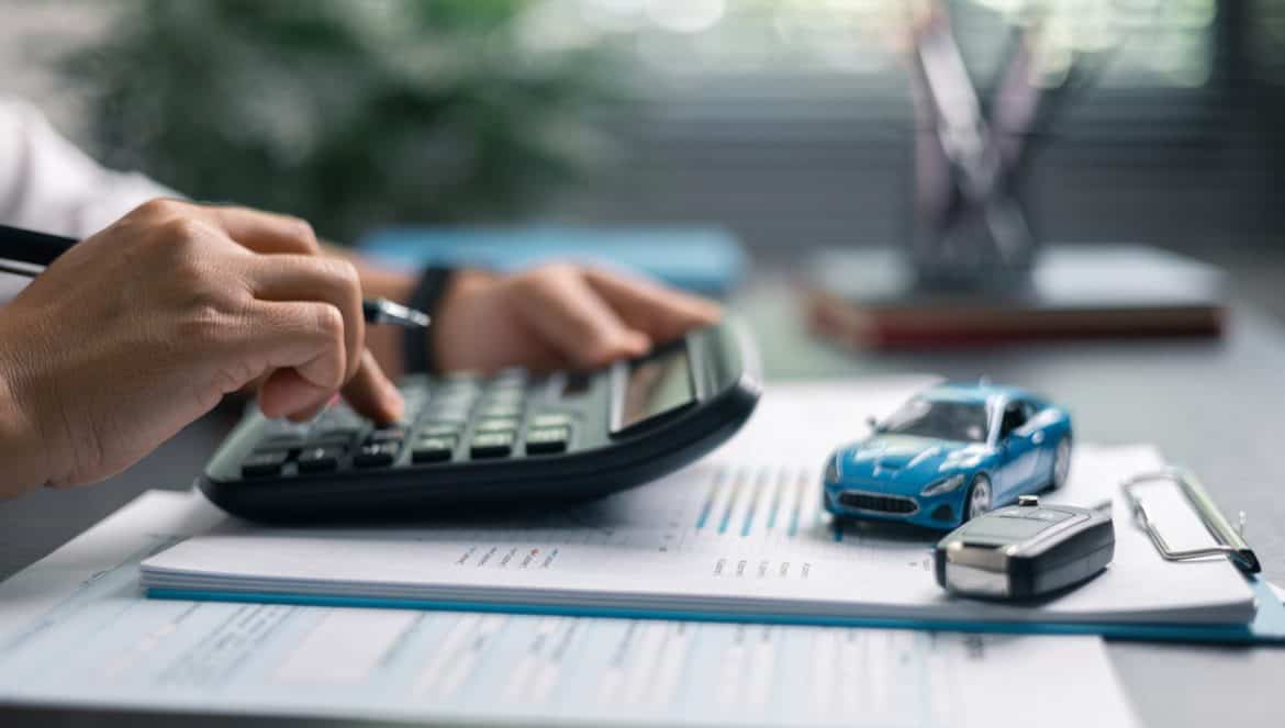 Finance bank tax expense accounting budget money businessman hand use Financial calculate accountant close up calculator with graph chart write office desk Business expense analysis saving home car
