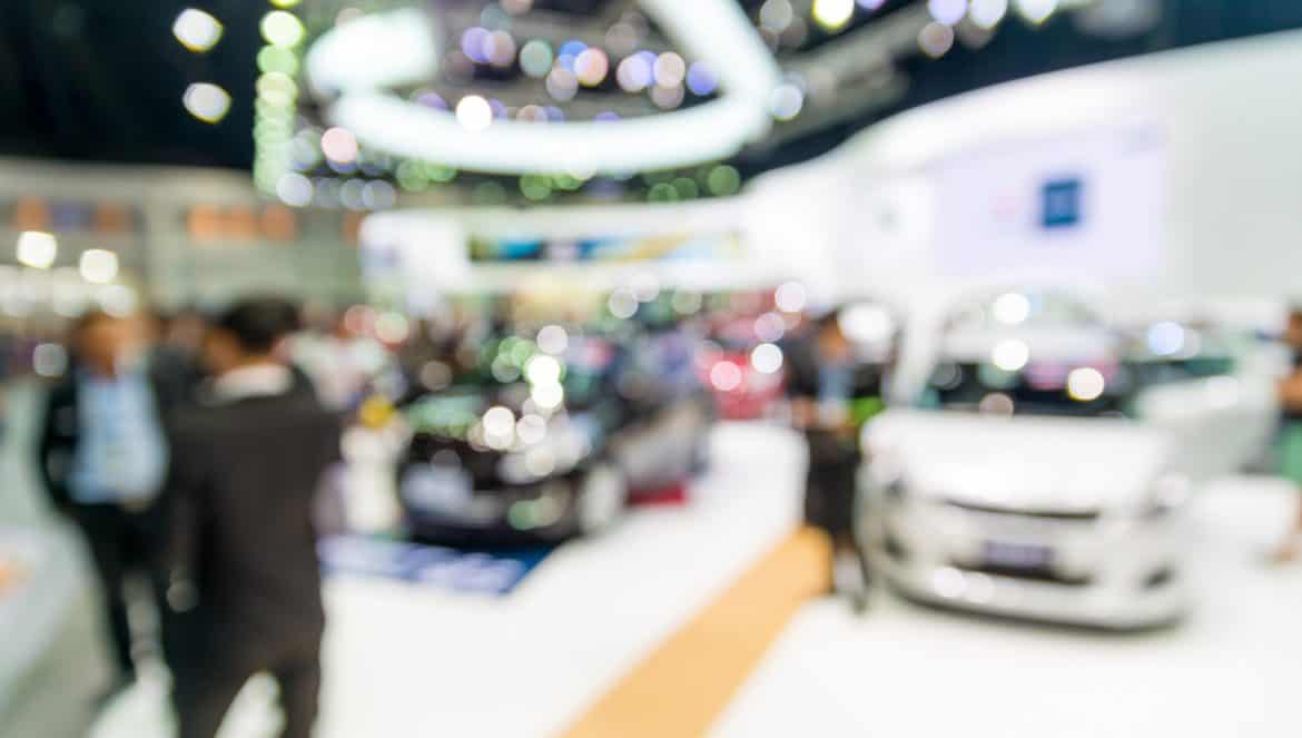 Abstract blur and defocused car and motor exhibition show interior for background
