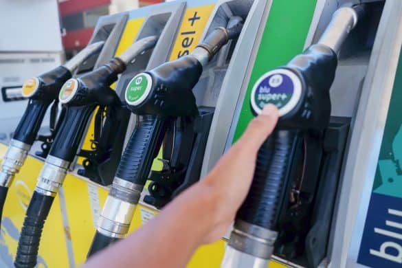 Mühlbach,Italy, August 18, 2019 - Close up shot of Asian customer holding a diesel fuel pump handle at gas station to refueling her vehicle, during Coronavirus pandemic